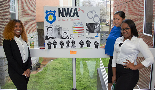 Students pose with their poster exhibit for the National African American Read-In Celebration