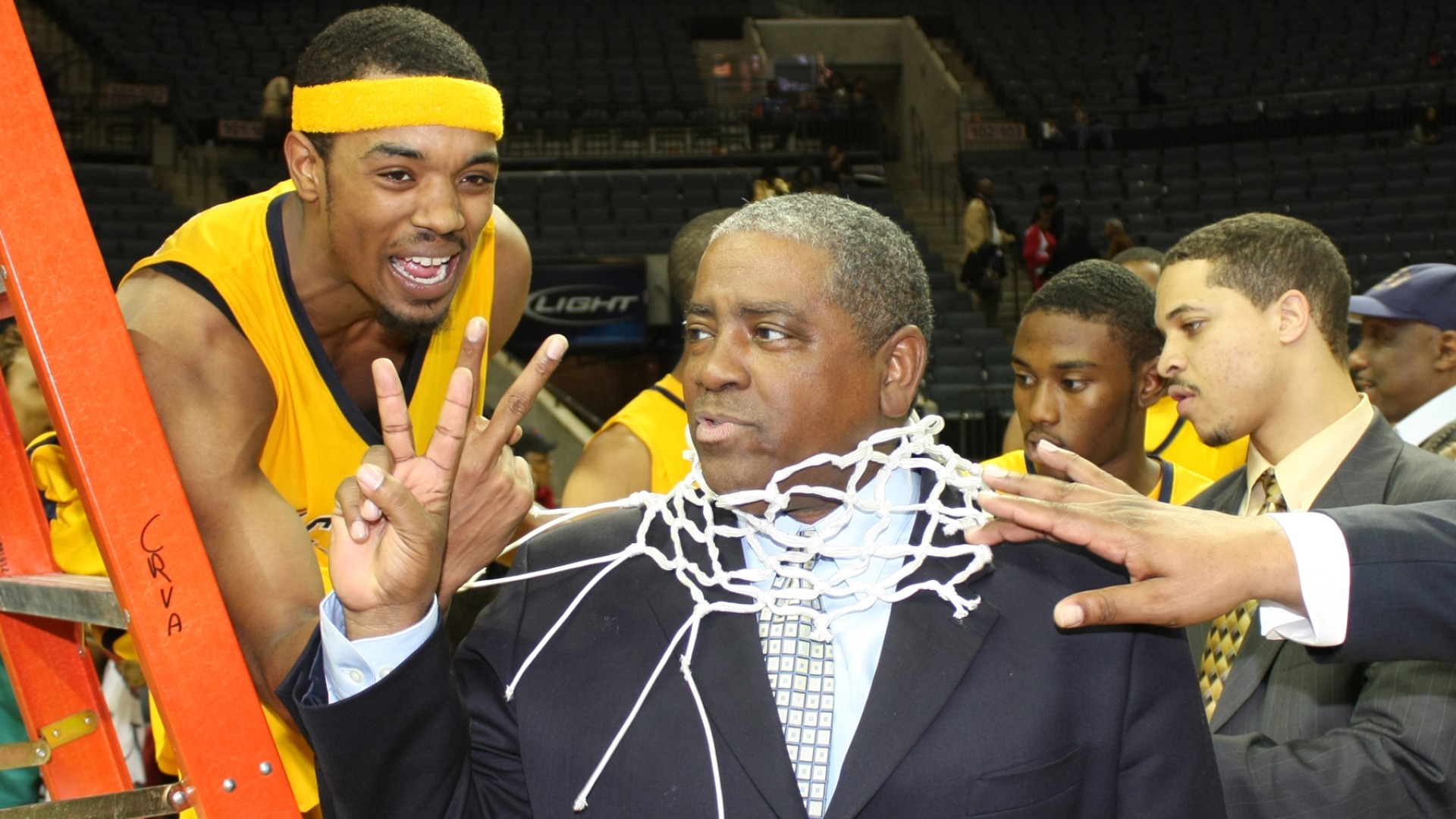 Steve Joyner with a basketball net around his head celebrating after the 2008 CIAA Championship