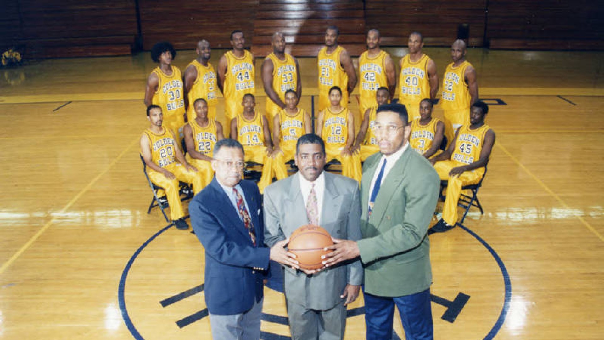 Photo of Steve Joyner with the Golden Bulls Basketball Team