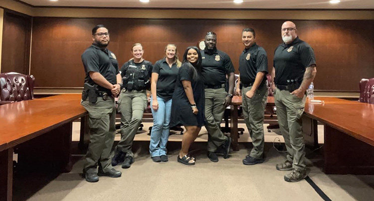 Niya Culbreth ’22 with officers from Mecklenburg County ABC Board