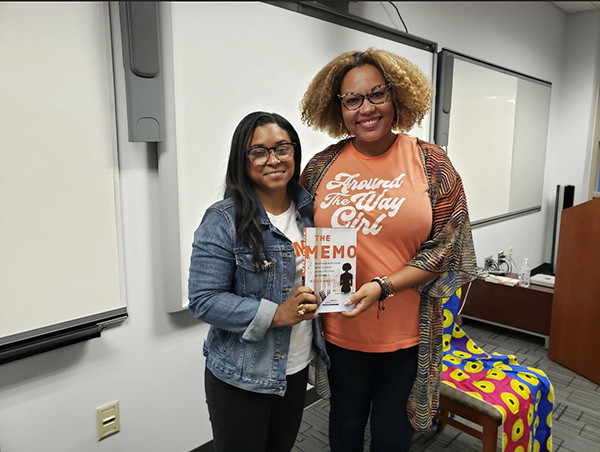 Minda Harts with Dr. Terza Lima-Neves poses with Harts' book
