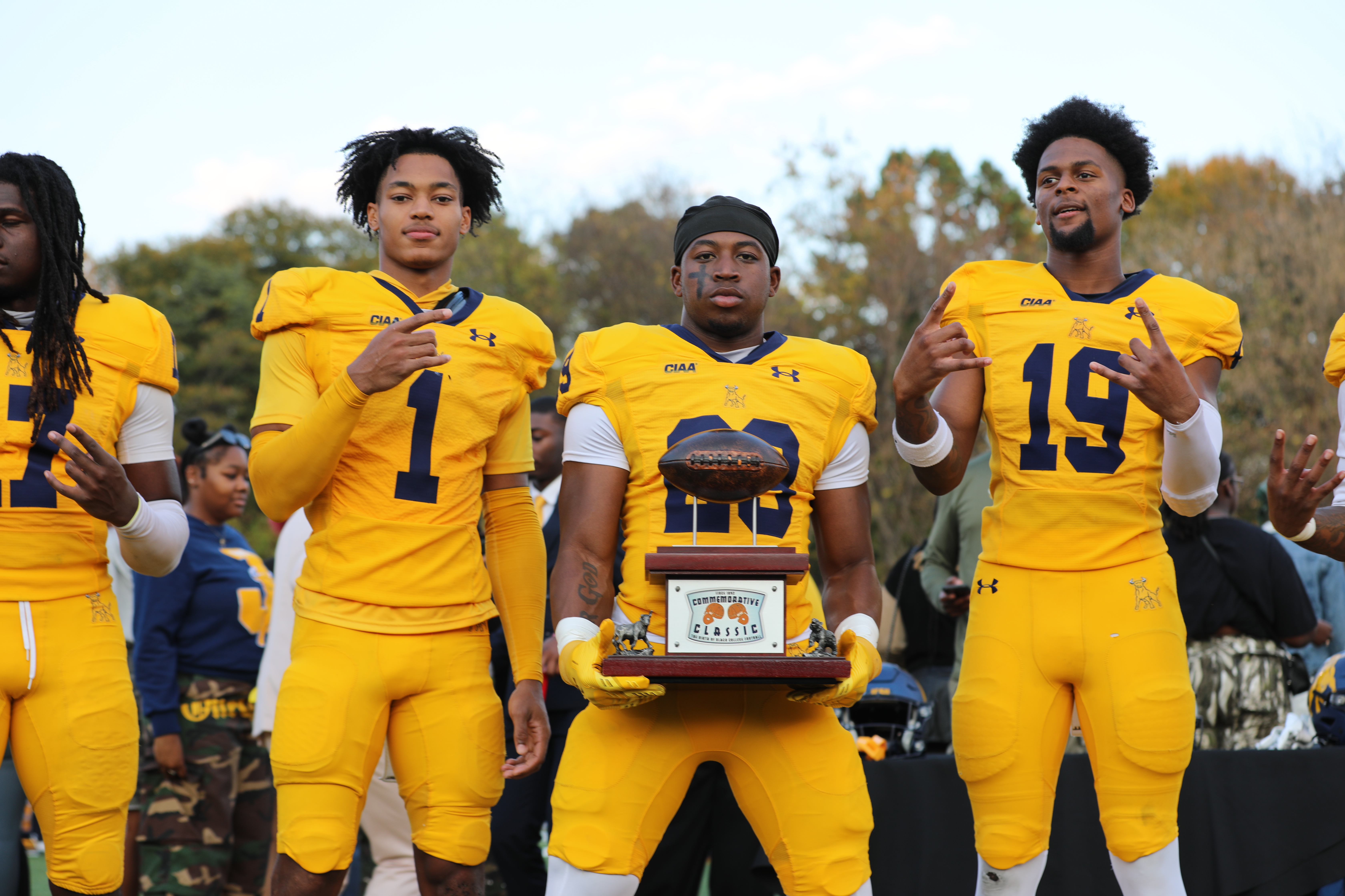 Players holding the Commemorative Classic trophy