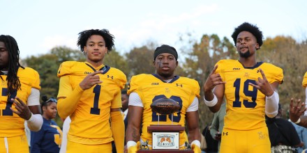 Players holding the Commemorative Classic trophy