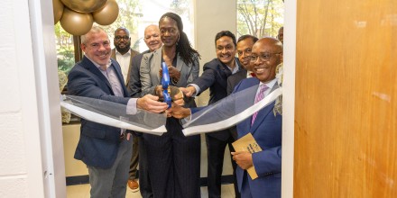Cutting the ribbon at the opening of the lab