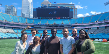 Students on the field at Panthers' Stadium