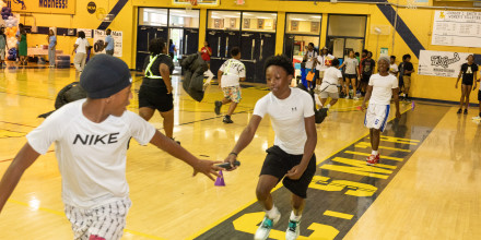 Kids at Impact Camp 2026 learning how track and field competitors  pass the baton 