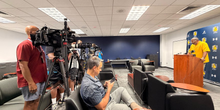 Photo of media talking to Coach Flowers