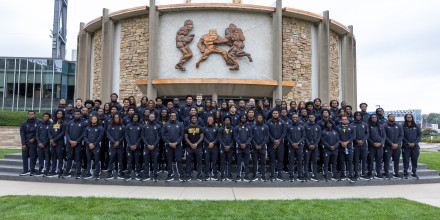 The 2026 Golden Bulls Football Team posing outside of the Hall of Fame