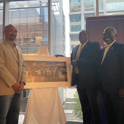 Steven Boyd, Al Washington and Clarence D. Armbrister pose with artwork
