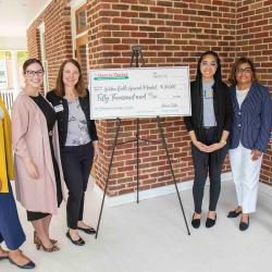 Representatives of JCSU and Harris Teeter pose with an oversized check for $50,000
