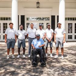 Photo of the JCSU Golf team players for the Sifford Cup posing with James Black