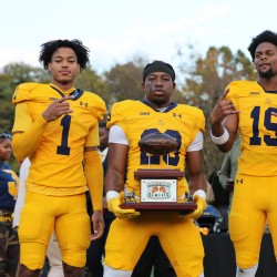 Players holding the Commemorative Classic trophy