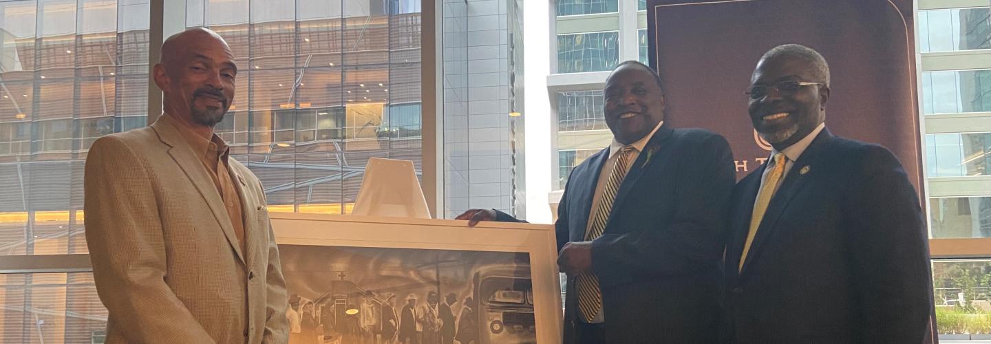 Steven Boyd, Al Washington and Clarence D. Armbrister pose with artwork