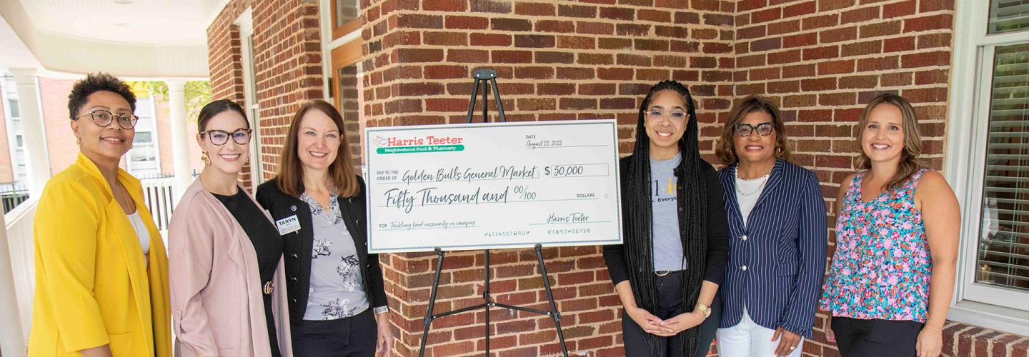 Representatives of JCSU and Harris Teeter pose with an oversized check for $50,000