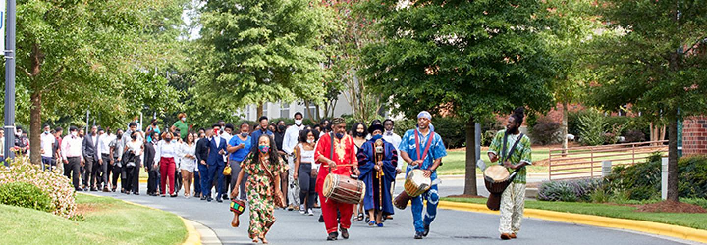 Students processing across campus to the church