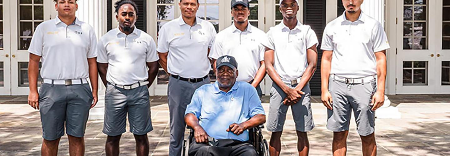 Photo of the JCSU Golf team players for the Sifford Cup posing with James Black