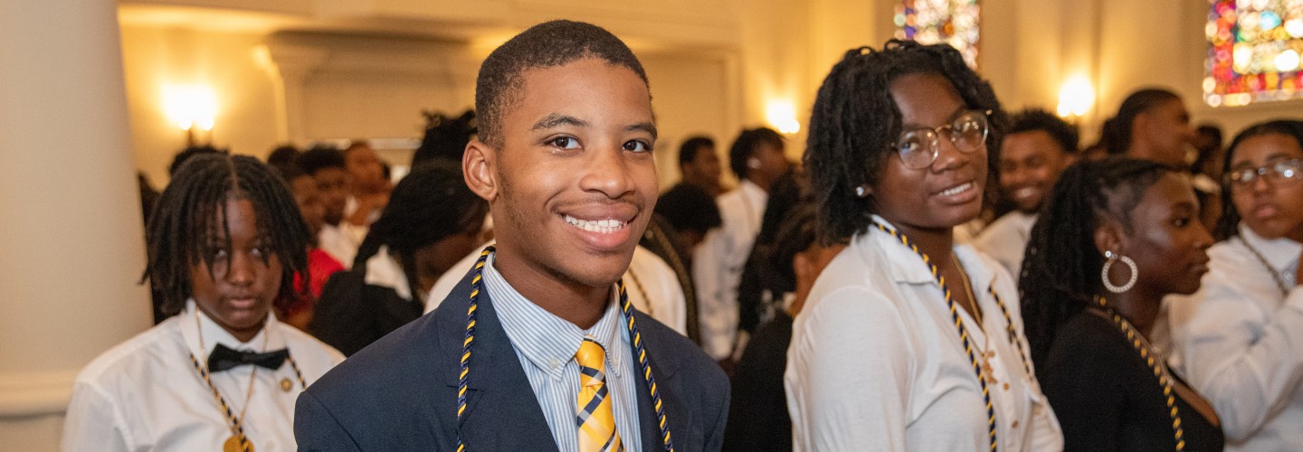Student smiling after pinning ceremony at the 2023 Freshman Convocation Ceremony