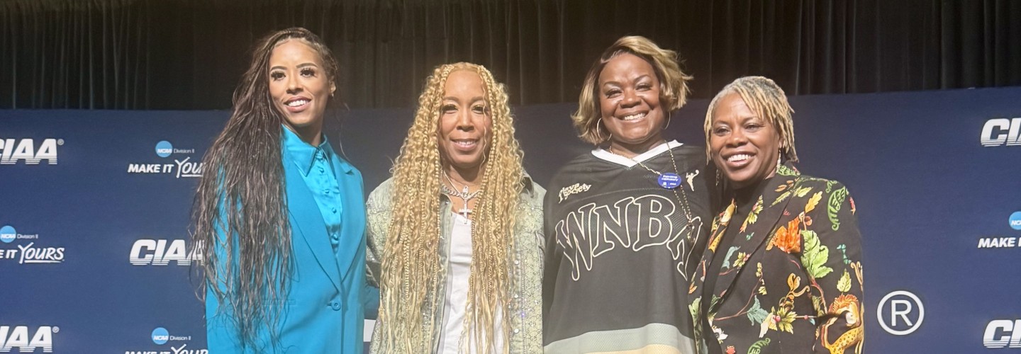 Swoopes poses for photo with others