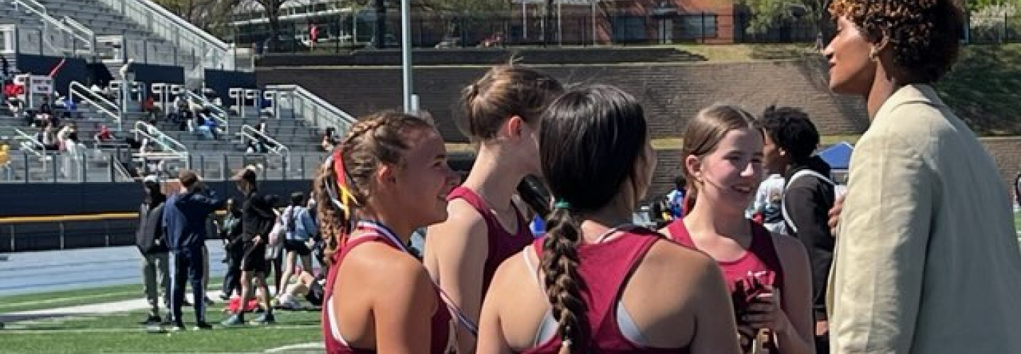 Anna Cockrell talks to students at the track meet
