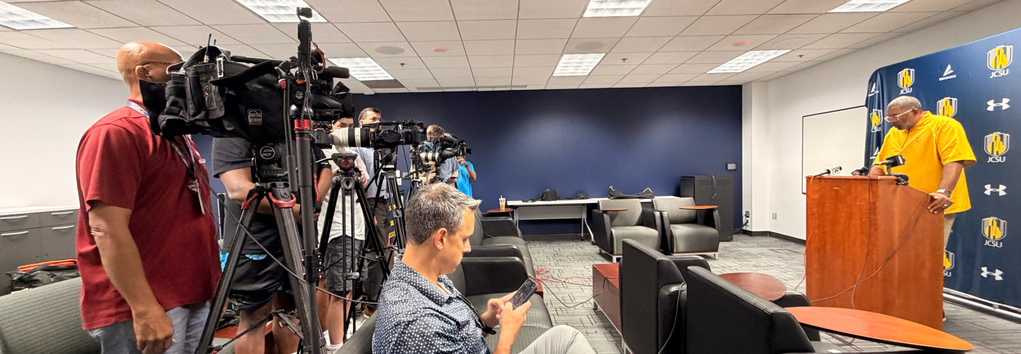 Photo of media talking to Coach Flowers