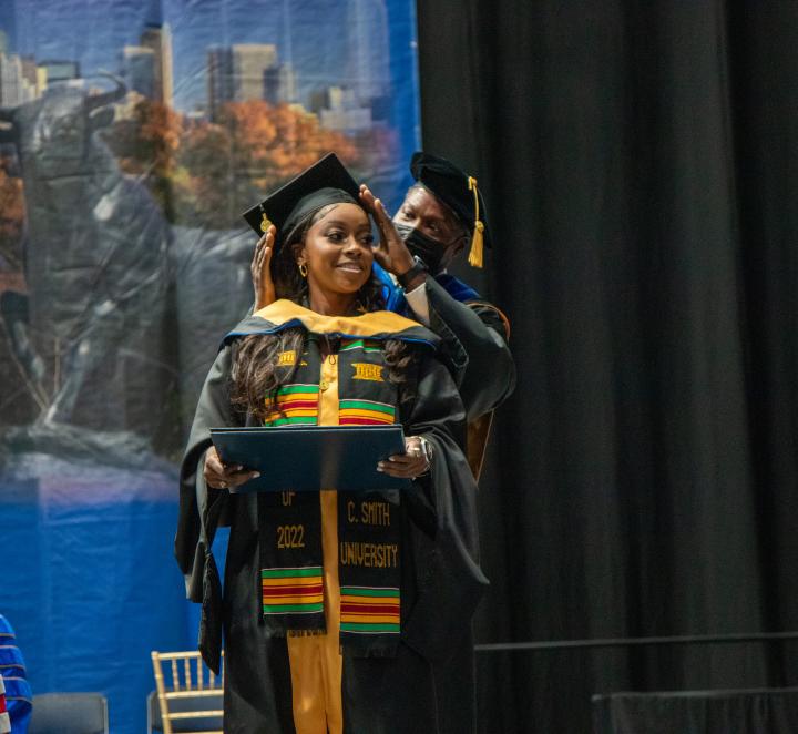 MSW student at commencement 2022 receiving hood