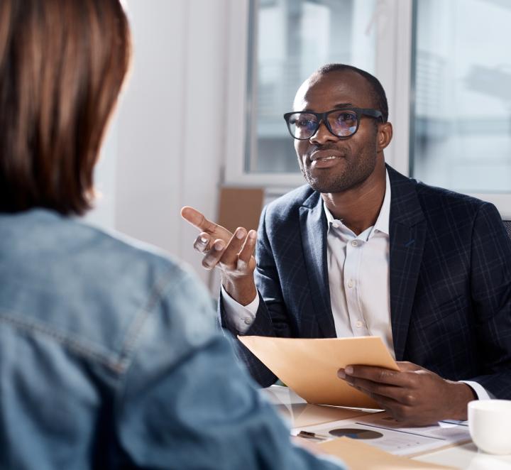 Photo of two people discussing business