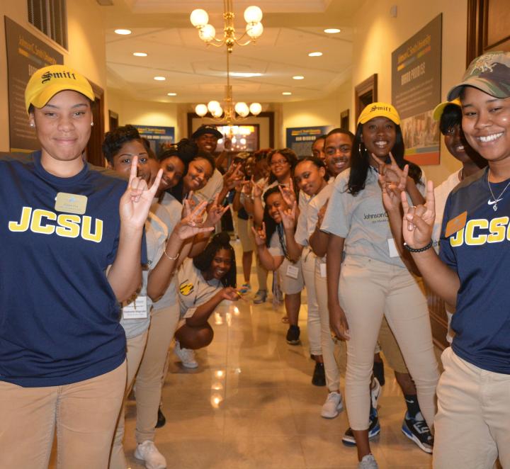 Students dressed in JCSU shirts welcoming people into Biddle Hall