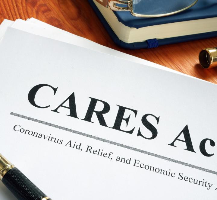 Photo of document that says "CARES Act" with pen sitting on top of it