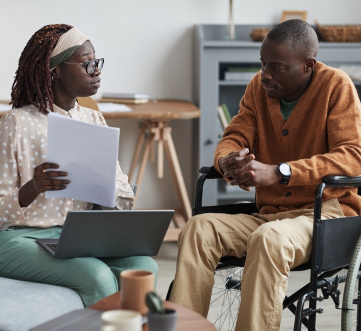 Woman sitting with a man in a wheelchair