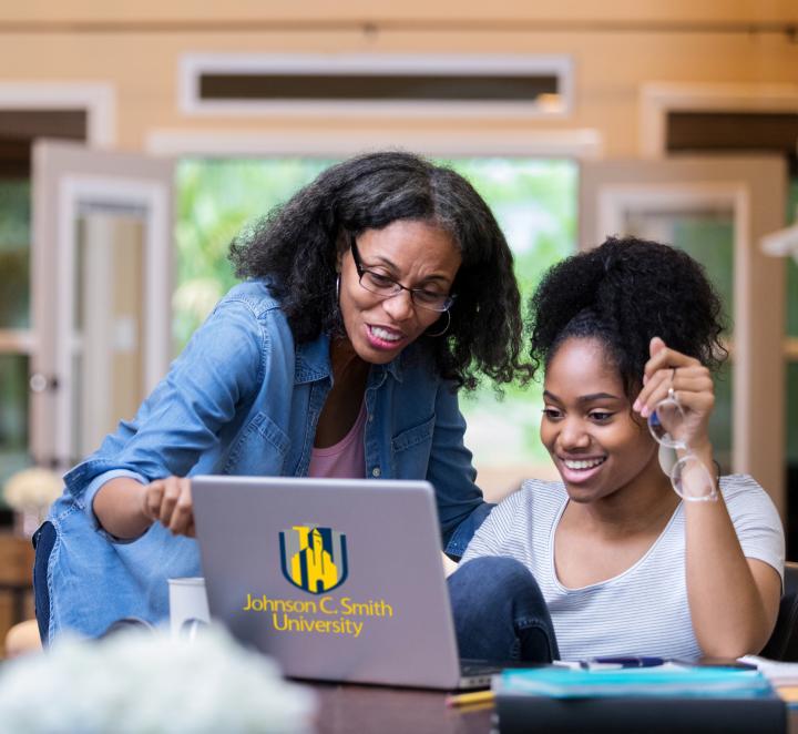 Two students looking at laptop