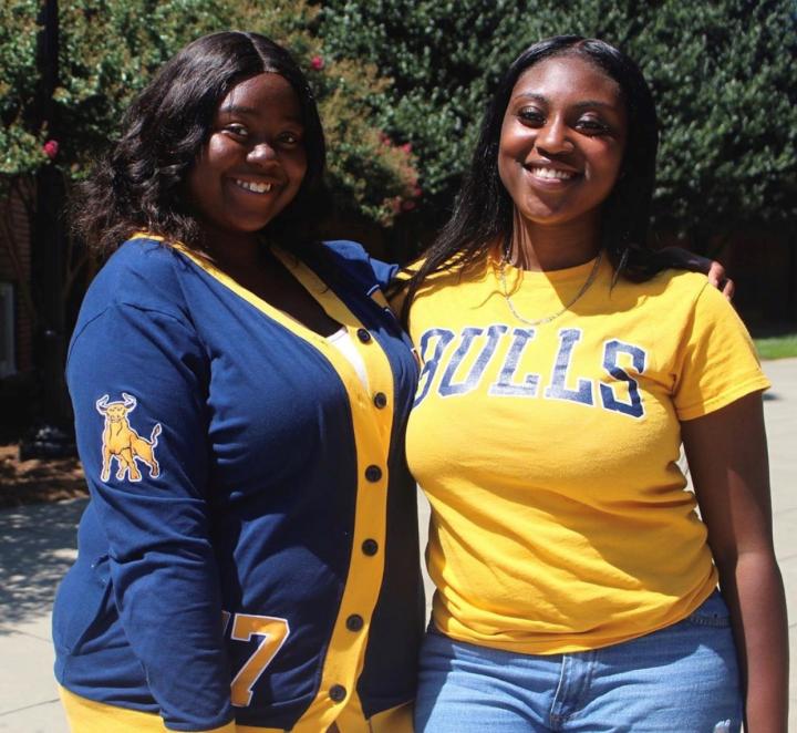 Two students wearing JCSU shirts