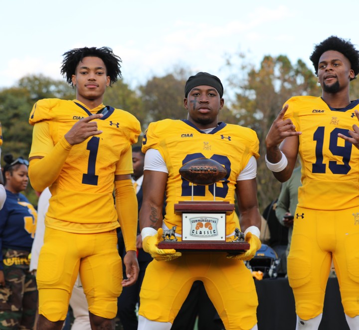 Players holding the Commemorative Classic trophy