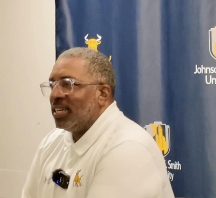 Coach Flowers speaking at the press conference in Boston before the Essence Classic