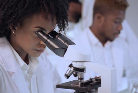 Woman looking into microscope