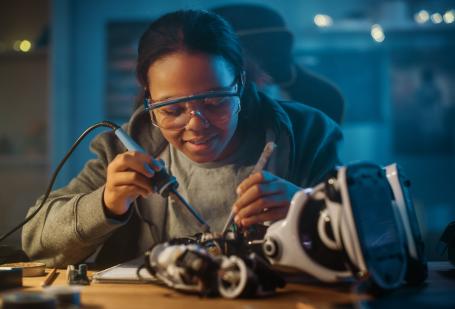 Student fixing a robot