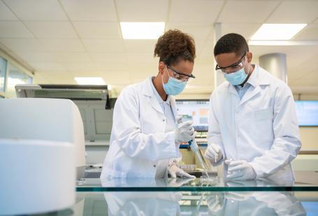 Two people in a lab working on an experiment