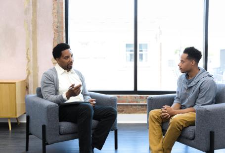 Two men talking during a counseling session