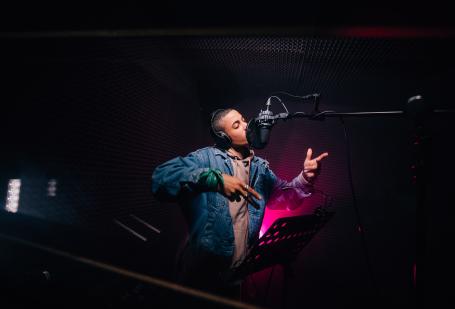 Young man singing into a microphone