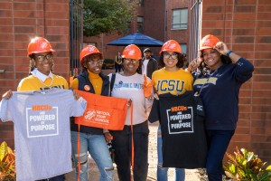 Students holding The Home Depot - Retool Your School Shirts