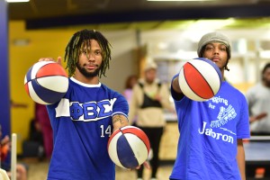 Students holding basketballs in Bull Pen