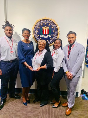 Students and Jennifer Joyner with FBI award