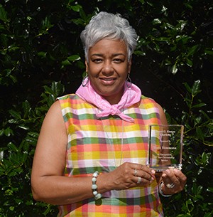 Tami B. Simmons holding the Susan G. Komen award