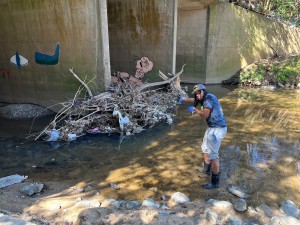 huntley next to pile of trash in water