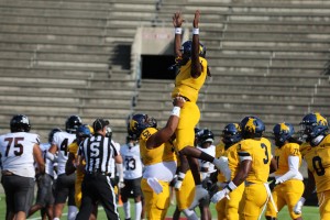 Golden Bulls players celebrate on the field