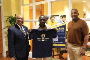 Dr. Eugene Okyere-Kwakye holds up a JCSU E Sports and Gaming Shirt with Dean Ogbuehi and Dr. Cash