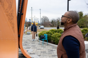 Utley looking at his artwork tin Five Points Plaza