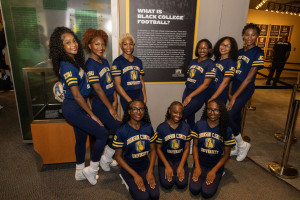 The Luv-A-Bulls surround the plaque that talks about the first Black College Football Game between JCSU (Biddle University) and Livingstone College