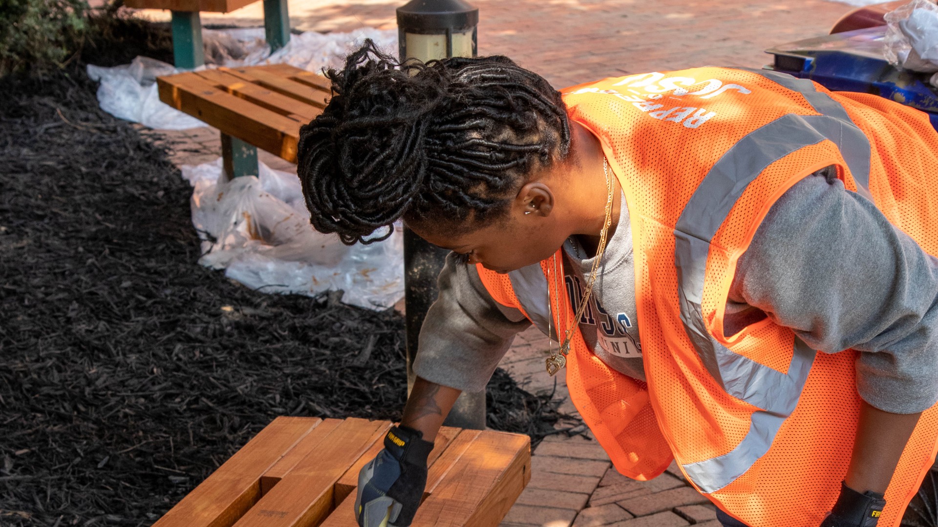 Volunteer repainting benches