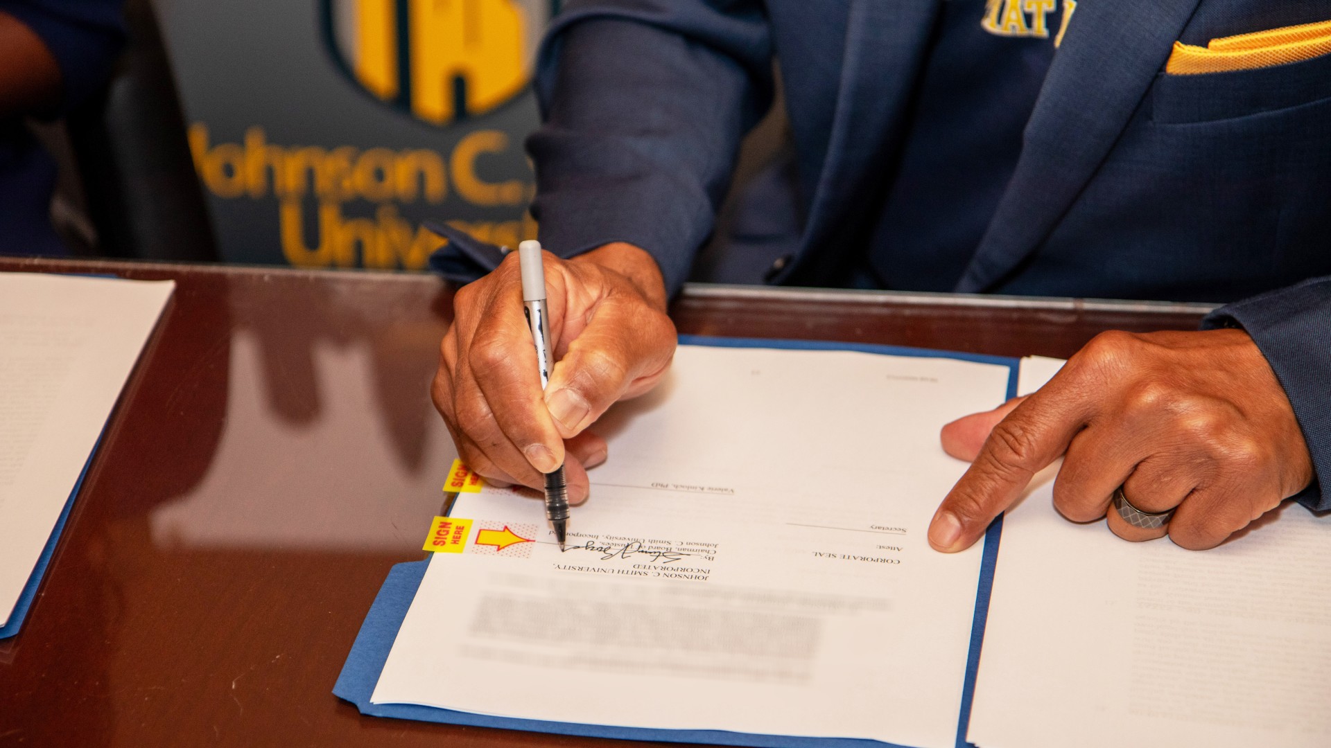 Steven L. Boyd signing the contracts