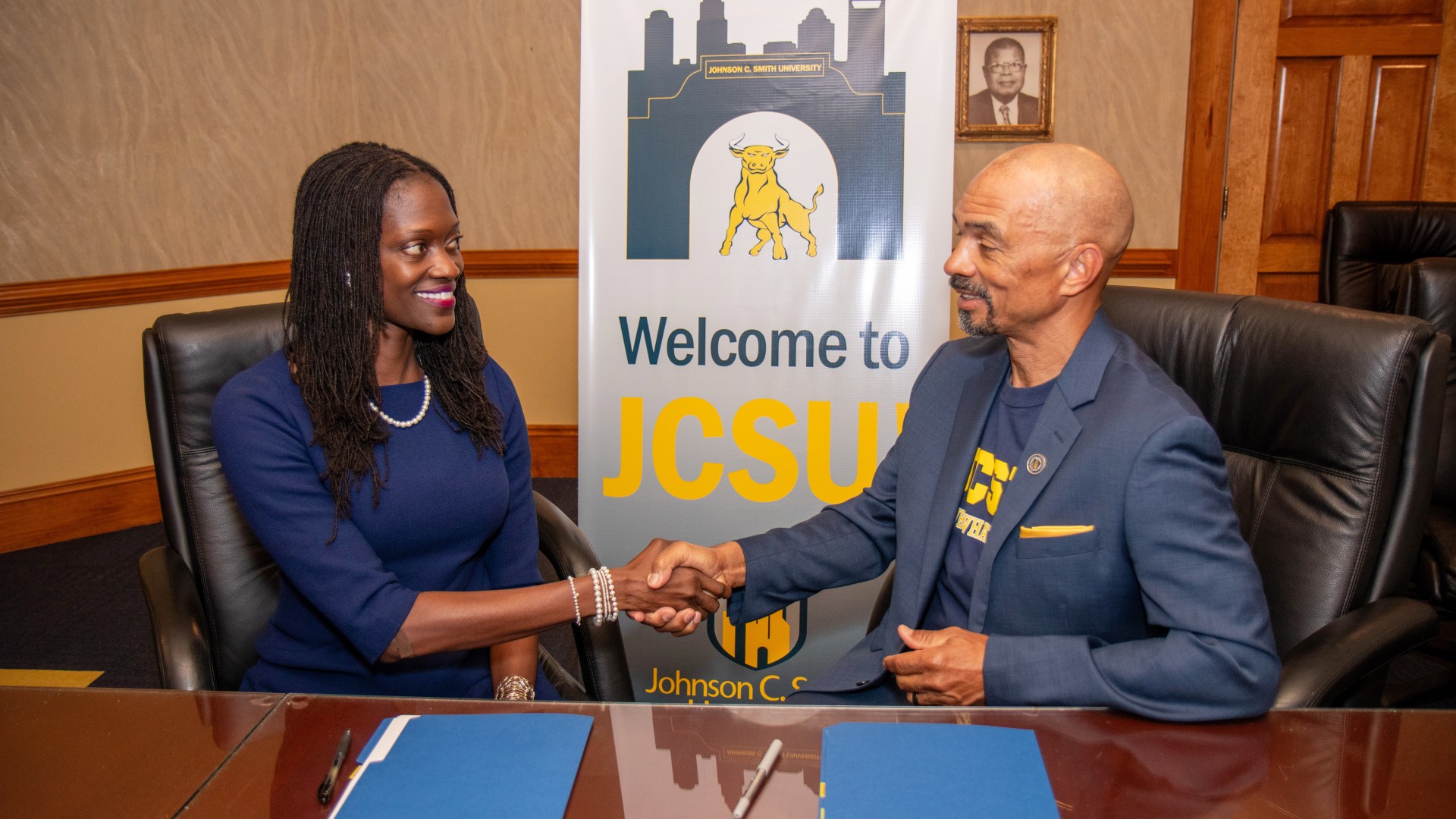 Dr. Valerie Kinloch and Trustee Steven L. Boyd shaking hands